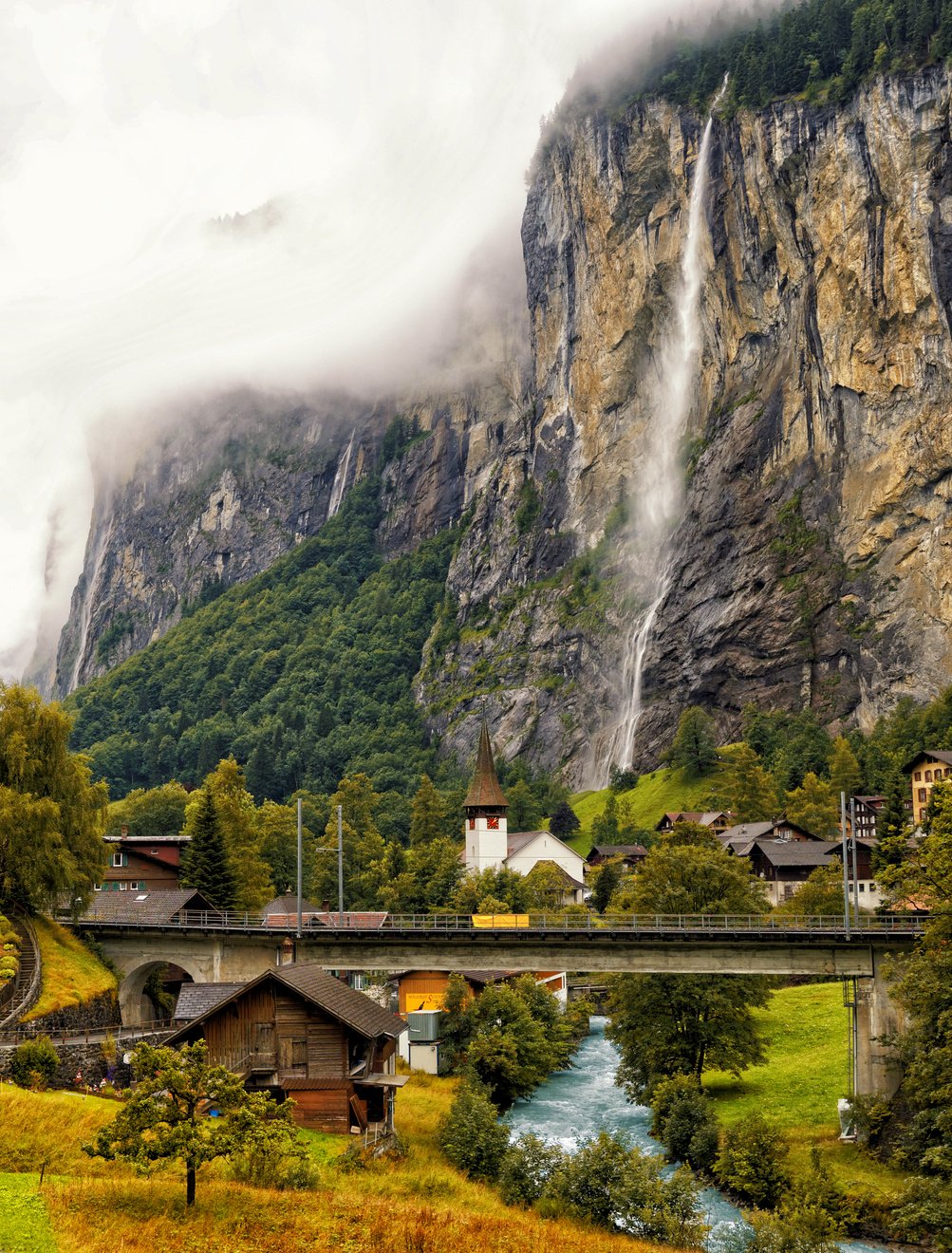 Majestic Waterfalls From A Rocky Mountain